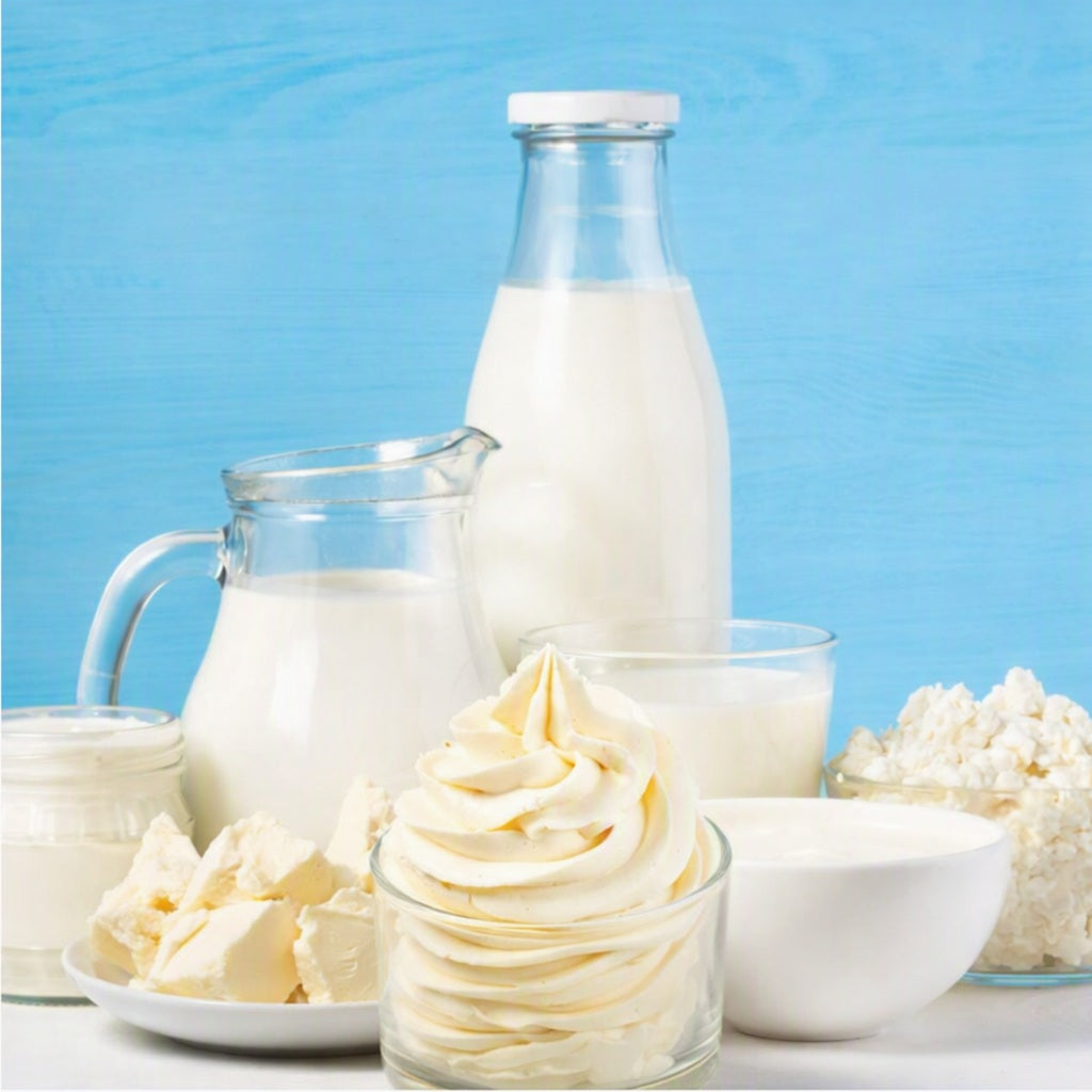 Buttercream Fragrance Oil is depicted by buttercream frosting surrounded by rich cream and butter cubes on plates and in bowls.