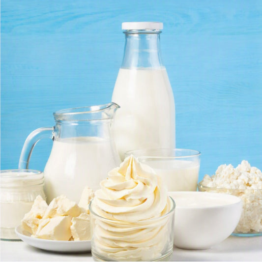 Buttercream Fragrance Oil is depicted by buttercream frosting surrounded by rich cream and butter cubes on plates and in bowls.