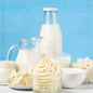 Buttercream Fragrance Oil is depicted by buttercream frosting surrounded by rich cream and butter cubes on plates and in bowls.
