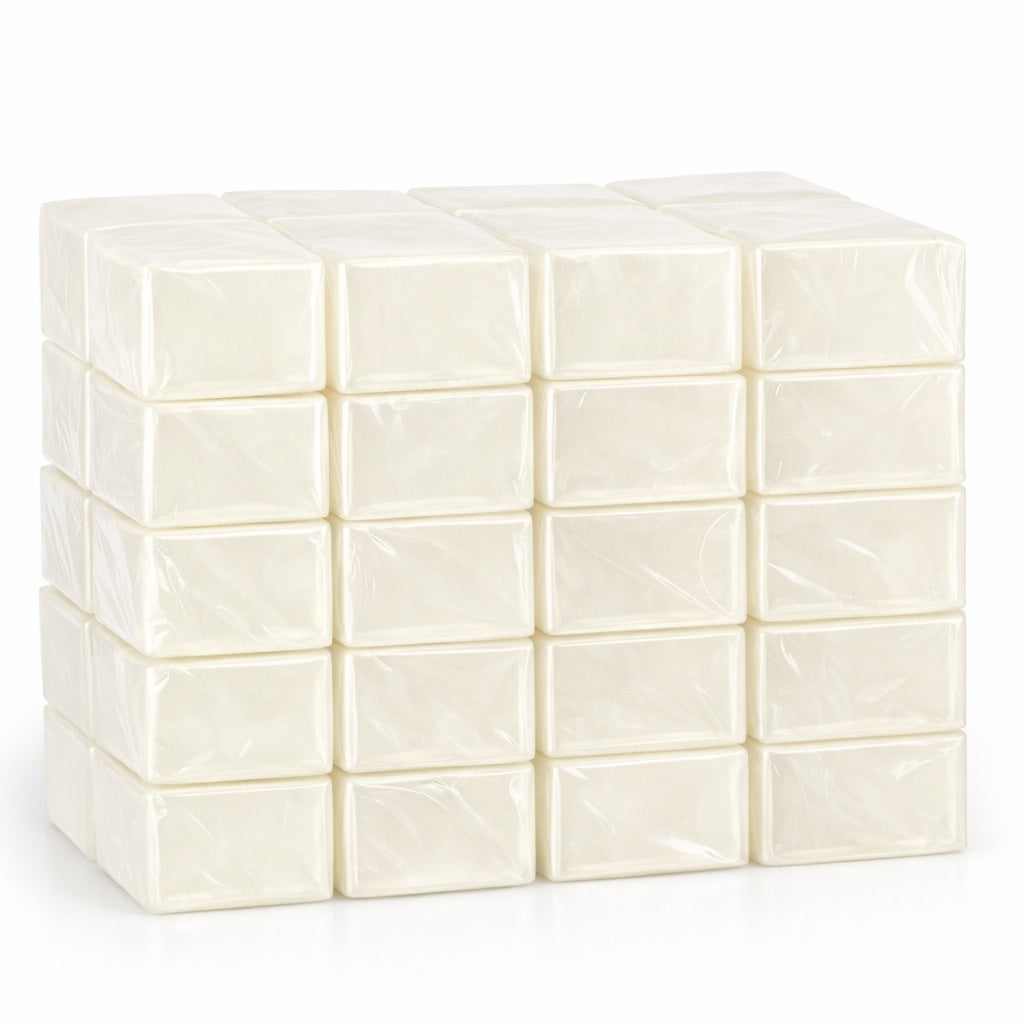 Forty cocoa‑butter melt and pour soap base blocks, individually wrapped and neatly stacked to show their smooth texture and quality for soap making.