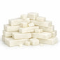 Creamy white cocoa‑butter melt and pour soap base pieces arranged on a white surface, including two larger rectangular blocks and three smaller hand‑cut cubes with a smooth matte texture.