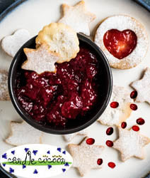 Cranberry Compote in a bowl surrounded by cookies
