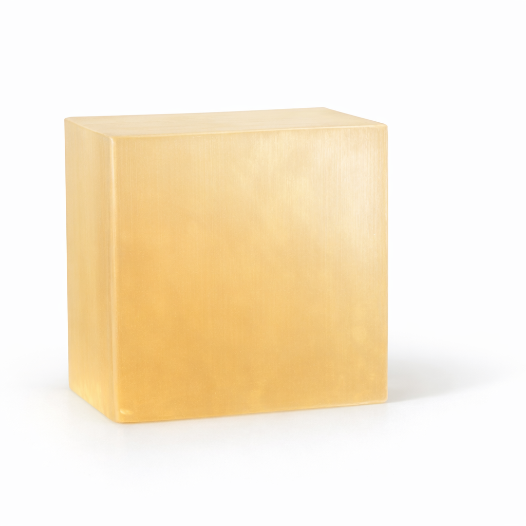 Low-sweat melt and pour soap base — hazy translucent block in warm pale yellow-orange color.