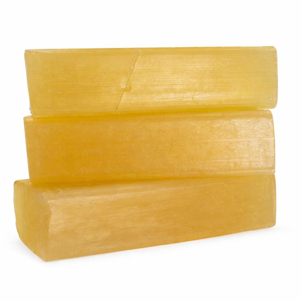 Olive Melt and Pour Soap Base — three translucent golden-yellow rectangular soap blocks stacked horizontally on a pure white background. The smooth, semi-transparent texture highlights the soap’s warm olive tone and handcrafted quality