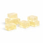 Five translucent light yellow cubes of soap base on a white background