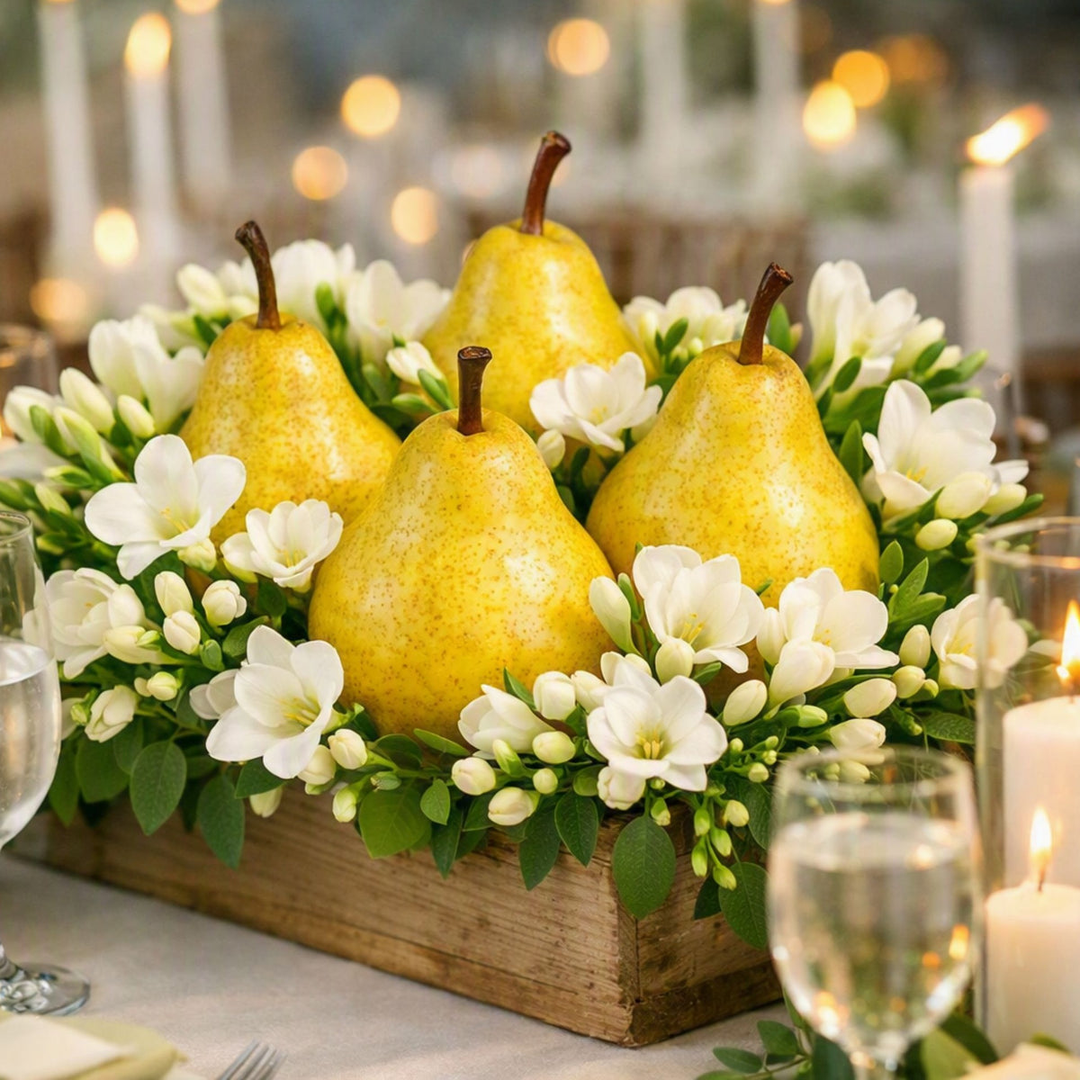 Pear and White Blossom Fragrance Oil is represented by juicy pears sitting in a box of freesia flowers on an elegant wedding day table.
