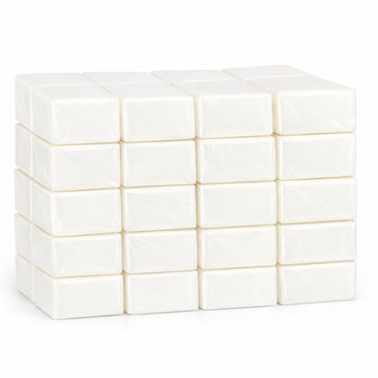 Fourty white shea melt and pour soap blocks individually wrapped stacked in a neat grid on a clean white background. Each black is smooth, rectangular, and wrapped in clear plastic with a soft matte finish, showing a uniform creamy-white color and subtle shadows beneath the stack