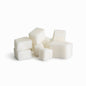Alt text: A cluster of small white shea melt and pour soap cubes arranged on a clean white background. The cubes have smooth, slightly rounded edges and a soft matte finish, showing subtle translucence and natural texture.