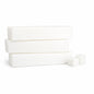 Three white soap bars stacked on a white background with two white cubes of cut up soap base