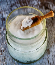 Organic Coconut Oil in a scoop and in a glass jar