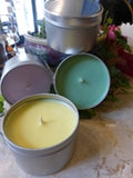 four candles made in tins from a kit
